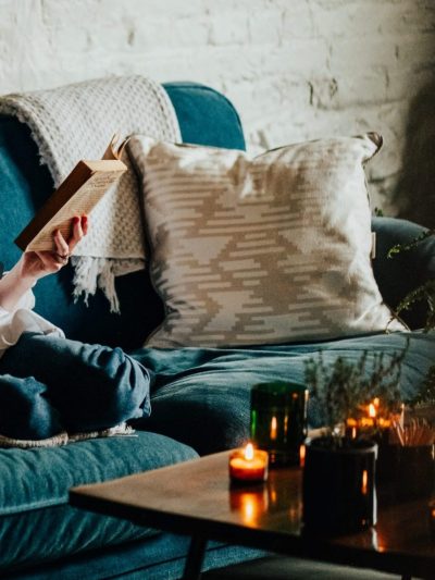 Natural cushions aztec print alpaca cushion on a comfy sofa with a woman reading a book