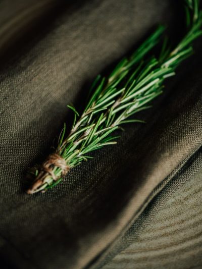 cloth table linens khaki linen napkin on a table with a sprig of rosemary on top for a luxury table setting