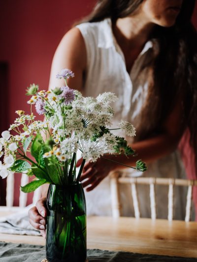 forest green vase on table with summer wildflowers
