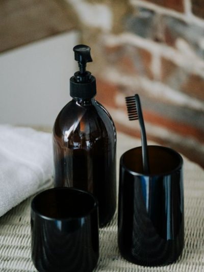 Amber bathroom accessories set brown glass Toothbrush pot with matching amber drinking glass made from recycled repurposed glass