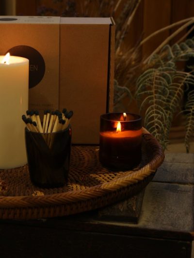 candles and matches sitting on a tray