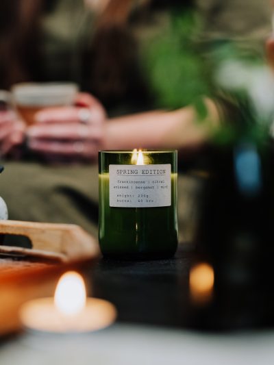 Seasonal living membership box with green spring candle lit on the table